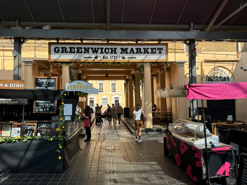 a group of people walking through a market area