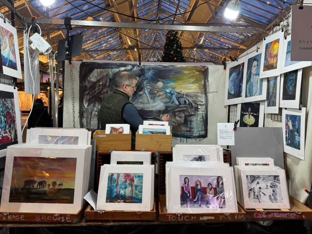 a man standing in front of a table filled with pictures